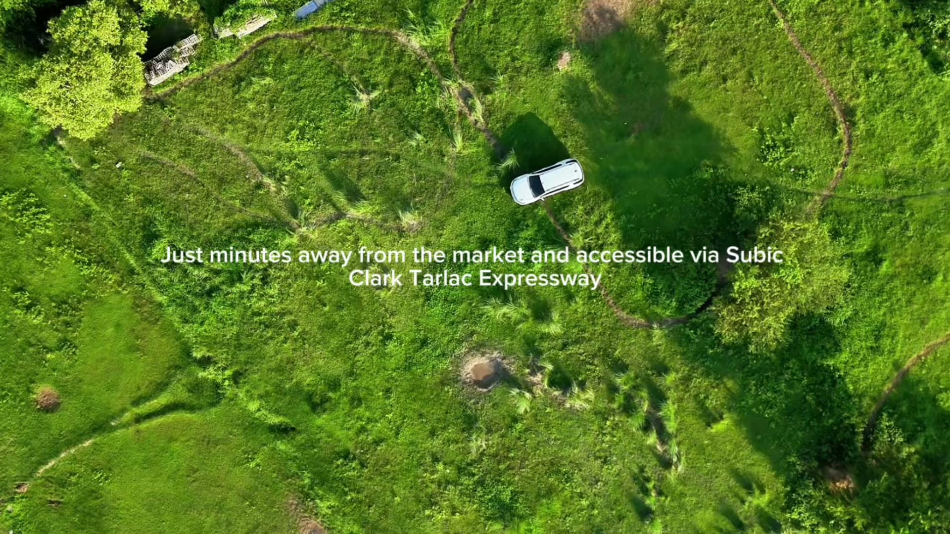 Top-down aerial view of the access road cutting through the property
